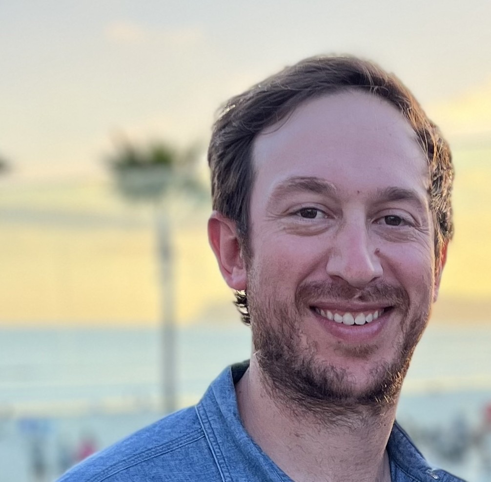 Jordan Plank smiling in a professional headshot.